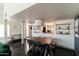 Dining room with hardwood floors, modern light fixture, and open access to the kitchen at 7930 E Arlington Rd # 8, Scottsdale, AZ 85250