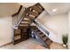 Staircase with carpet runner, metal railings, and built-in shelving for storage and decor at 7930 E Arlington Rd # 8, Scottsdale, AZ 85250