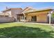 A well-maintained backyard features lush green lawn, covered patio, and inviting outdoor dining area at 7931 W Shaw Butte Dr, Peoria, AZ 85345