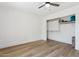 Minimalist bedroom with wood floors and a closet with shelving, providing ample storage space at 7931 W Shaw Butte Dr, Peoria, AZ 85345