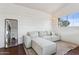 Bright living room with white shiplap walls, a comfortable sectional sofa, and large mirror at 7931 W Shaw Butte Dr, Peoria, AZ 85345
