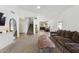 Spacious living area with hardwood floors, a comfortable sofa, and an open floor plan leading to the kitchen at 7931 W Shaw Butte Dr, Peoria, AZ 85345