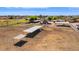 Scenic aerial view of horse property, multiple shelters, and green pasture, perfect for equestrian enthusiasts at 836 W Lenora Way, San Tan Valley, AZ 85140