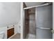 A well-lit bathroom featuring tile shower with sliding door, tiled floor, and neutral decor at 836 W Lenora Way, San Tan Valley, AZ 85140