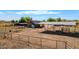 Aerial view of fenced equestrian property with shelters, barn, and open land, ideal for horse lovers at 836 W Lenora Way, San Tan Valley, AZ 85140