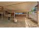 Inside a well-maintained horse stall with metal gate and hay feeding container at 836 W Lenora Way, San Tan Valley, AZ 85140