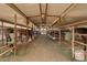 Interior view of horse stalls with multiple horses inside, offering excellent care at 836 W Lenora Way, San Tan Valley, AZ 85140