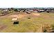Aerial view of sprawling land featuring pastures, covered shelters and open space for recreation at 836 W Lenora Way, San Tan Valley, AZ 85140