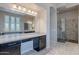 Bathroom with a granite counter, vanity and mirror, with a walk-in shower at 8504 S 30Th St, Phoenix, AZ 85042