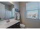 Bathroom with a gray vanity, mirror, and window with natural light, and a towel rack at 8504 S 30Th St, Phoenix, AZ 85042