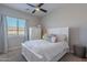 Bright bedroom with a ceiling fan, white furniture, and a window with blinds at 8504 S 30Th St, Phoenix, AZ 85042