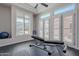 Well-lit exercise room with black floors, workout bench, and bright window views at 8504 S 30Th St, Phoenix, AZ 85042