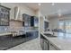 Modern kitchen with stainless steel hood, granite countertops, and spacious center island at 8504 S 30Th St, Phoenix, AZ 85042