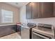 Well-equipped laundry room with modern washer, dryer, and storage cabinets at 8504 S 30Th St, Phoenix, AZ 85042