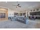 Open-concept living area with a large sectional sofa and seamless flow to the kitchen and dining area at 8504 S 30Th St, Phoenix, AZ 85042