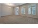 Bright living room features neutral walls and carpet, shuttered windows, and archway entrance at 8504 S 30Th St, Phoenix, AZ 85042