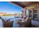 Inviting covered patio with wicker furniture and view of the outdoor living and pool area at 8504 S 30Th St, Phoenix, AZ 85042
