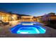 Backyard oasis featuring a luxurious pool, spa, and a cozy gazebo with evening lights at 8504 S 30Th St, Phoenix, AZ 85042