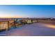 Rooftop deck featuring city skyline views and metal railings at dusk at 8504 S 30Th St, Phoenix, AZ 85042