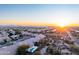Aerial shot of a residential neighborhood with desert landscape and a stunning sunset at 9238 E Palm Tree Dr, Scottsdale, AZ 85255