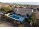 Aerial view showcasing a beautiful home, pool, outdoor seating, and lush desert landscape at 9238 E Palm Tree Dr, Scottsdale, AZ 85255