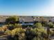 Scenic aerial shot of backyard, pool, desert landscape, and mountain views at 9238 E Palm Tree Dr, Scottsdale, AZ 85255