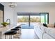 Kitchen island with bar seating overlooking the outdoor pool and desert landscape through sliding glass doors at 9238 E Palm Tree Dr, Scottsdale, AZ 85255