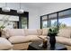 Comfortable living room with a large sectional sofa, modern decor, and a seamless connection to the outdoors at 9238 E Palm Tree Dr, Scottsdale, AZ 85255
