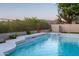 Inviting pool featuring crisp clear water, elevated tanning deck, mountain views, and lush desert landscaping at 9238 E Palm Tree Dr, Scottsdale, AZ 85255