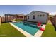 Gorgeous pool in backyard with artificial grass, a basketball hoop, and covered seating at 9718 E Radioactive Dr, Mesa, AZ 85212