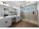 Elegant bathroom showcasing a glass-enclosed shower, dual sinks, and vanity area at 9718 E Radioactive Dr, Mesa, AZ 85212