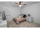 This bedroom features neutral carpet, ceiling fan, and neutral-toned walls at 9718 E Radioactive Dr, Mesa, AZ 85212