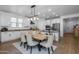 The dining room features a decorative light fixture, white cabinets, and granite countertops at 9718 E Radioactive Dr, Mesa, AZ 85212