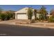 Attractive home featuring desert landscaping, a two-car garage, and inviting curb appeal at 9718 E Radioactive Dr, Mesa, AZ 85212