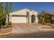 Inviting home exterior boasting a well-kept lawn, desert landscaping, and a two-car garage at 9718 E Radioactive Dr, Mesa, AZ 85212