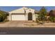 Charming home with a well-manicured lawn, desert landscaping, and a two-car garage at 9718 E Radioactive Dr, Mesa, AZ 85212