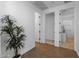 Hallway with wood floors and an indoor plant with doors to other rooms at 9718 E Radioactive Dr, Mesa, AZ 85212