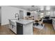 Bright kitchen island features stainless dishwasher, white cabinets, granite countertop, and black faucet at 9718 E Radioactive Dr, Mesa, AZ 85212