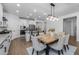 The kitchen features stainless steel appliances, decorative lighting, white cabinets, and access to the dining room at 9718 E Radioactive Dr, Mesa, AZ 85212