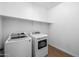 Bright laundry room with newer white washer and dryer at 9718 E Radioactive Dr, Mesa, AZ 85212