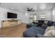 Bright living room showcasing tile floors, a ceiling fan, and large comfortable sectional sofa at 9718 E Radioactive Dr, Mesa, AZ 85212