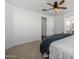 This main bedroom features neutral carpet, ceiling fan, and neutral-toned walls at 9718 E Radioactive Dr, Mesa, AZ 85212