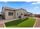 Spacious backyard with synthetic lawn, outdoor kitchen, and covered patio area at 9738 E Tiburon Ave, Mesa, AZ 85212