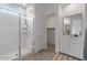 Bright bathroom featuring a glass enclosed shower, white vanity and a walk-in closet at 9738 E Tiburon Ave, Mesa, AZ 85212