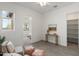Bright bedroom boasts a neutral palette, wood-look flooring, and an adjacent walk-in closet at 9738 E Tiburon Ave, Mesa, AZ 85212