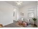 Bright bonus room featuring two chairs and two pink ottomans at 9738 E Tiburon Ave, Mesa, AZ 85212