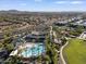 Aerial view of a community pool with palm trees, lush landscaping, clubhouse and ample parking spaces at 9738 E Tiburon Ave, Mesa, AZ 85212
