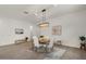 Well-lit dining area featuring a modern chandelier, tile flooring, and white walls at 9738 E Tiburon Ave, Mesa, AZ 85212