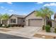Beautiful single-Gathering home with manicured landscaping and a two-car garage on a sunny day at 9738 E Tiburon Ave, Mesa, AZ 85212
