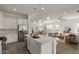 Open-concept kitchen with island, stainless steel appliances, and view into the adjacent living area at 9738 E Tiburon Ave, Mesa, AZ 85212